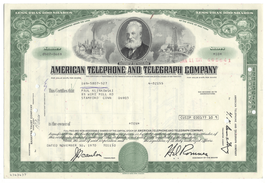Vintage stock certificate of American Telephone and Telegraph Company with a portrait and green border.