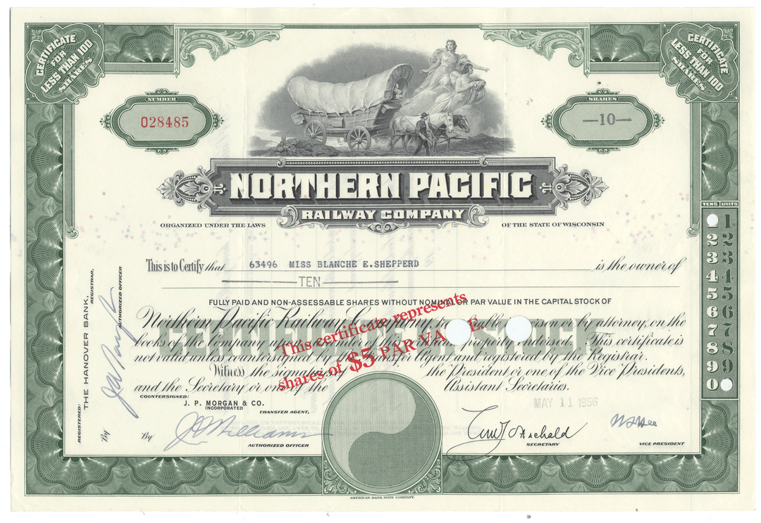 An antique Northern Pacific Railway Company stock certificate from 1956 with ornate green border engraving and a covered wagon illustration at the top